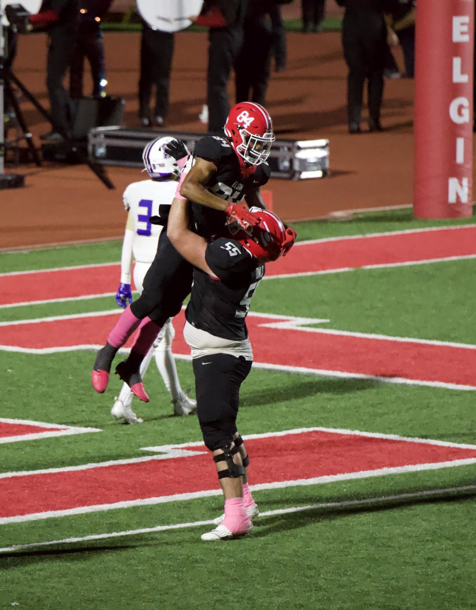 Elgin players Treyvon Crabtree (84) and Keith Ferguson celebrate a touchdown during a recent game.